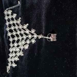 Silvertone hand bracelet and ring